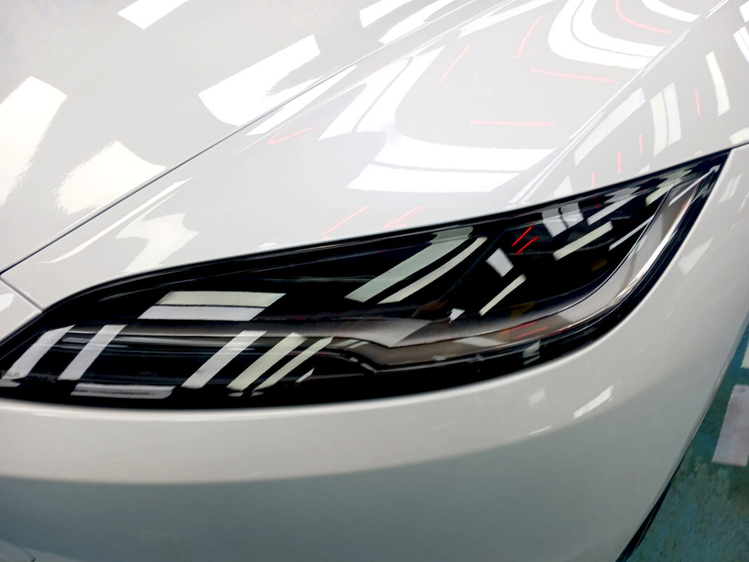 The Model 3's coated paintwork showing clean reflections.