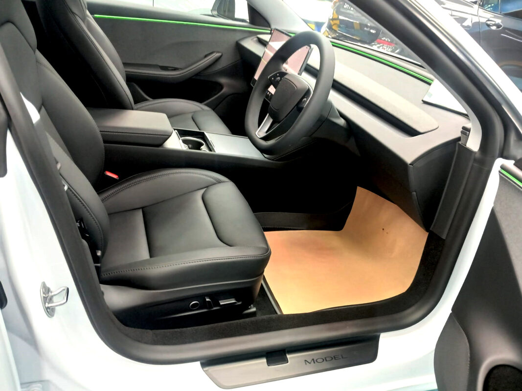 The Tesla Model 3 parked in the workshop, freshly coated.