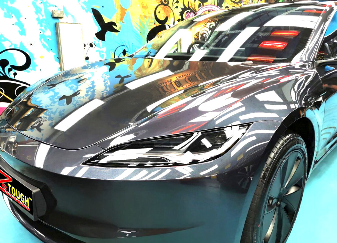 The Tesla Model 3 from a side angle after the ceramic coating.