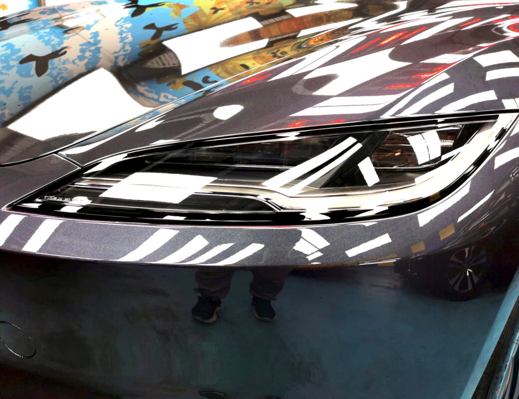 The Model 3's coated paintwork showing clean reflections.