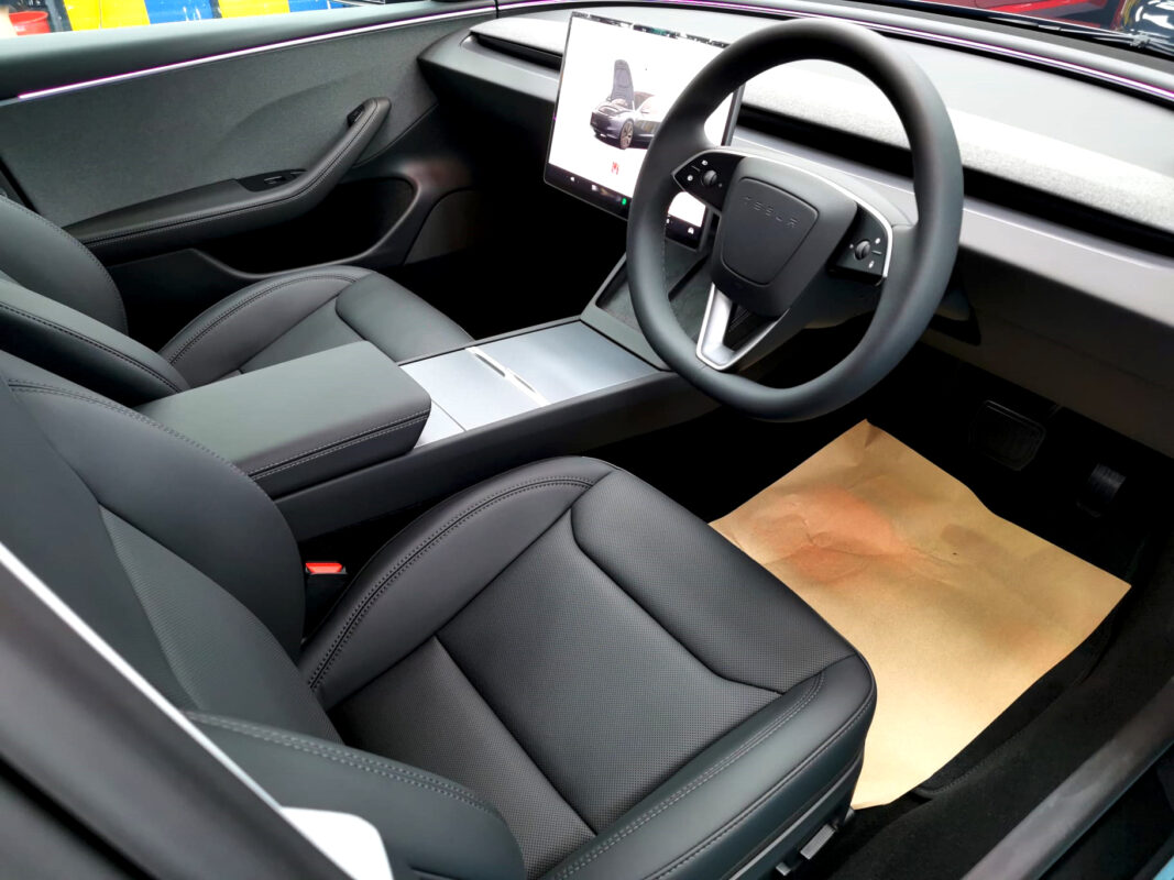 The Tesla Model 3 parked in the workshop, freshly coated.
