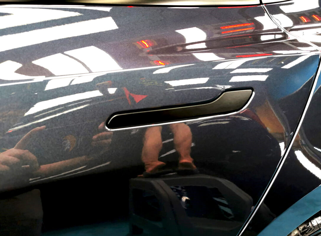 Front three-quarter view of the Tesla Model 3 after coating.