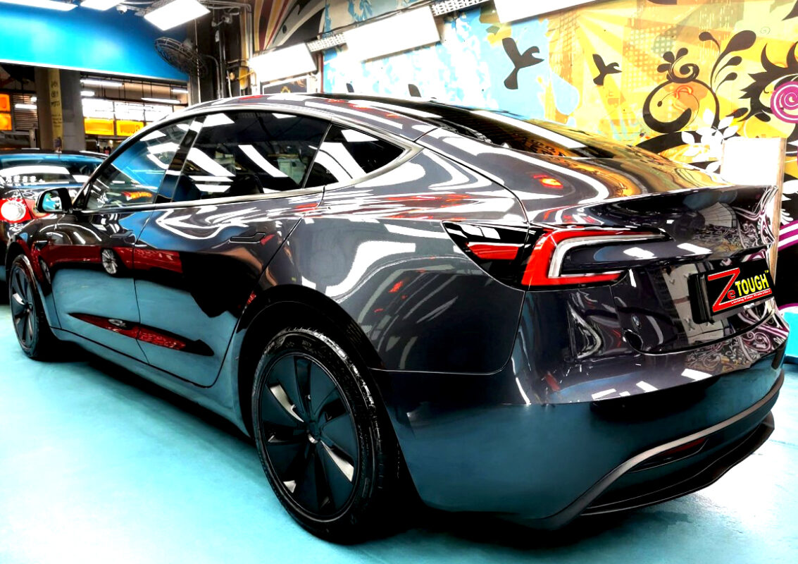 Rear quarter of the Tesla Model 3, glossy and protected.