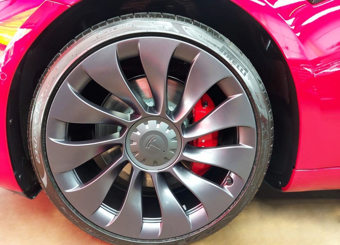 The red Tesla Model 3, finished and ready for collection.