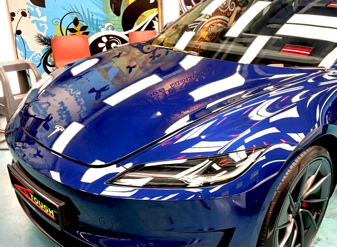The Tesla Model 3 from a side angle after the titanium coating.
