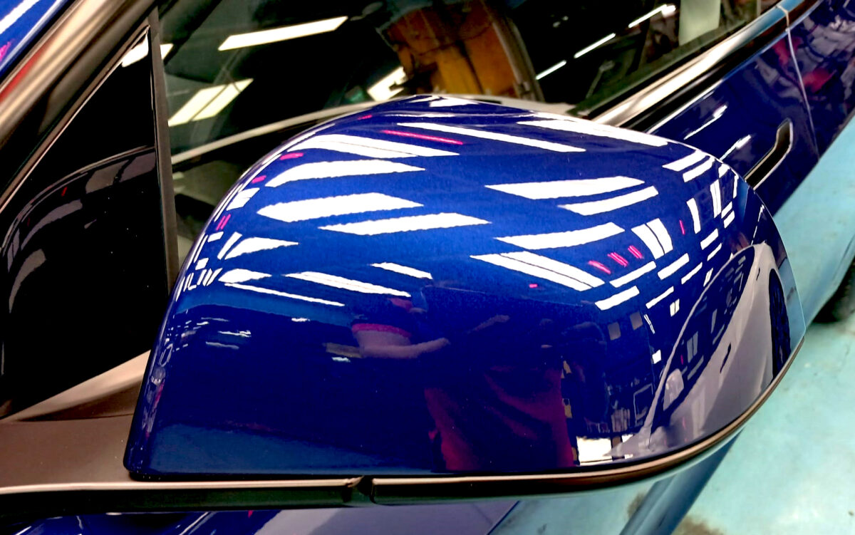 The Tesla Model 3 parked in the workshop, freshly coated.