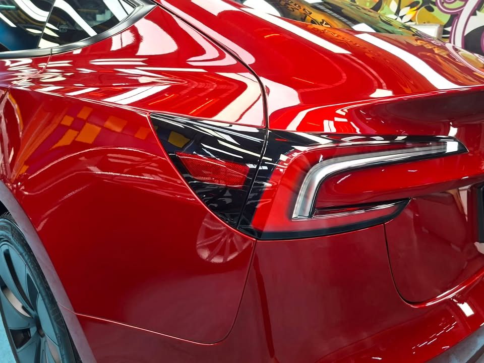 Close-up of the tail lamp and red rear quarter panel.