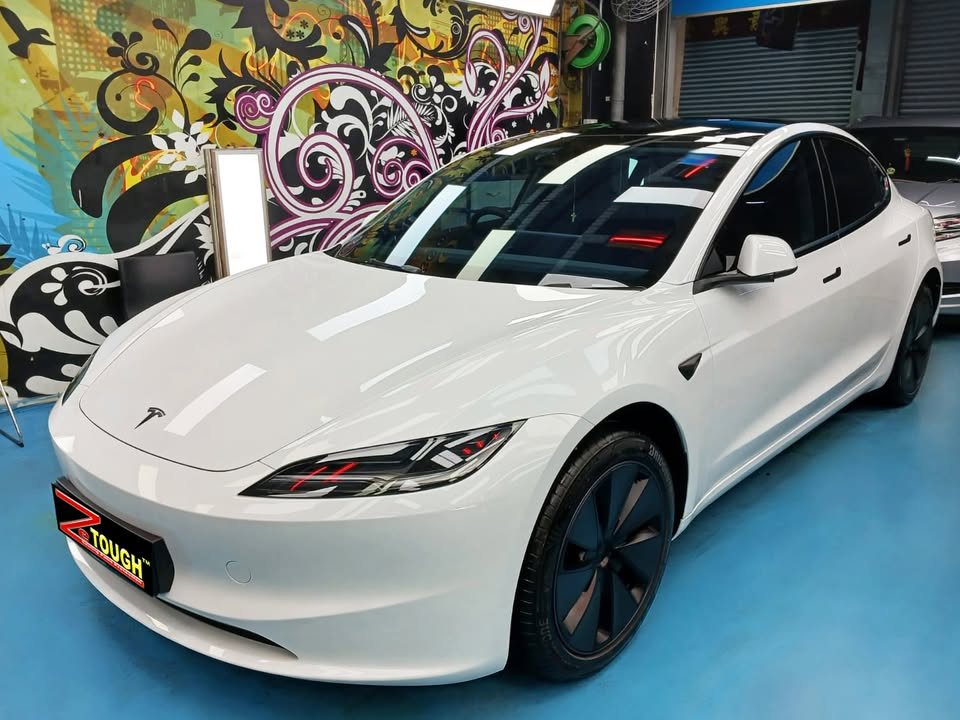 White Tesla Model 3 from the front three-quarter, its bonnet glossy after the ZeTough Ceramic coating.
