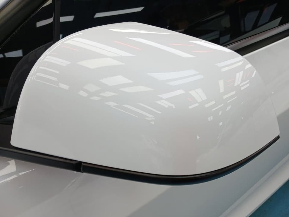 White door mirror cap on the Tesla Model 3 with a clean gloss.
