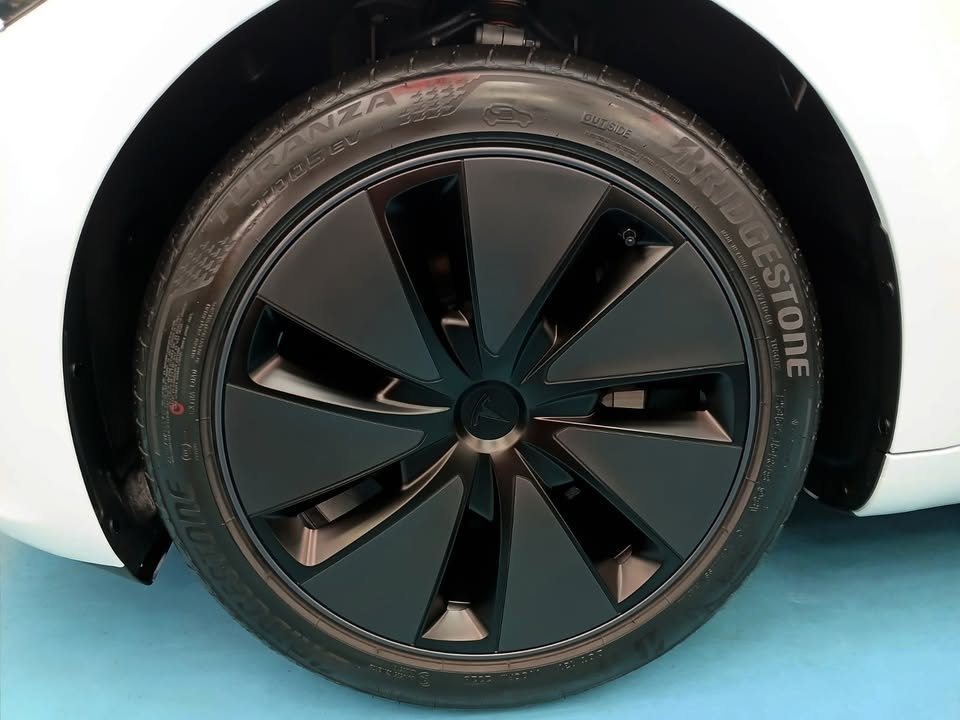 Black aero wheel and tyre on the Tesla Model 3.