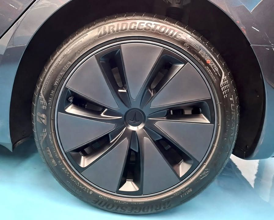 Aero wheel cover and Bridgestone tyre on the Tesla, freshly cleaned.