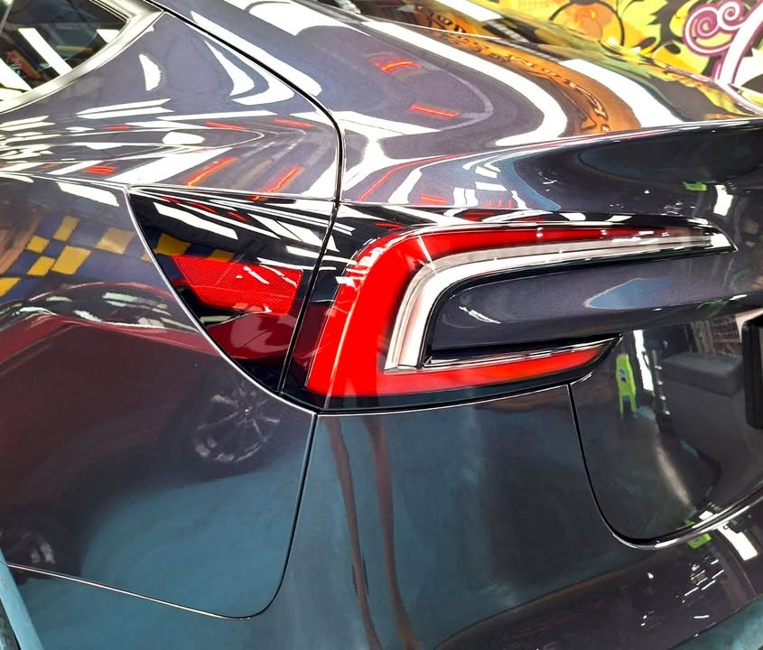 Tail lamp and rear quarter of the Tesla Model 3.