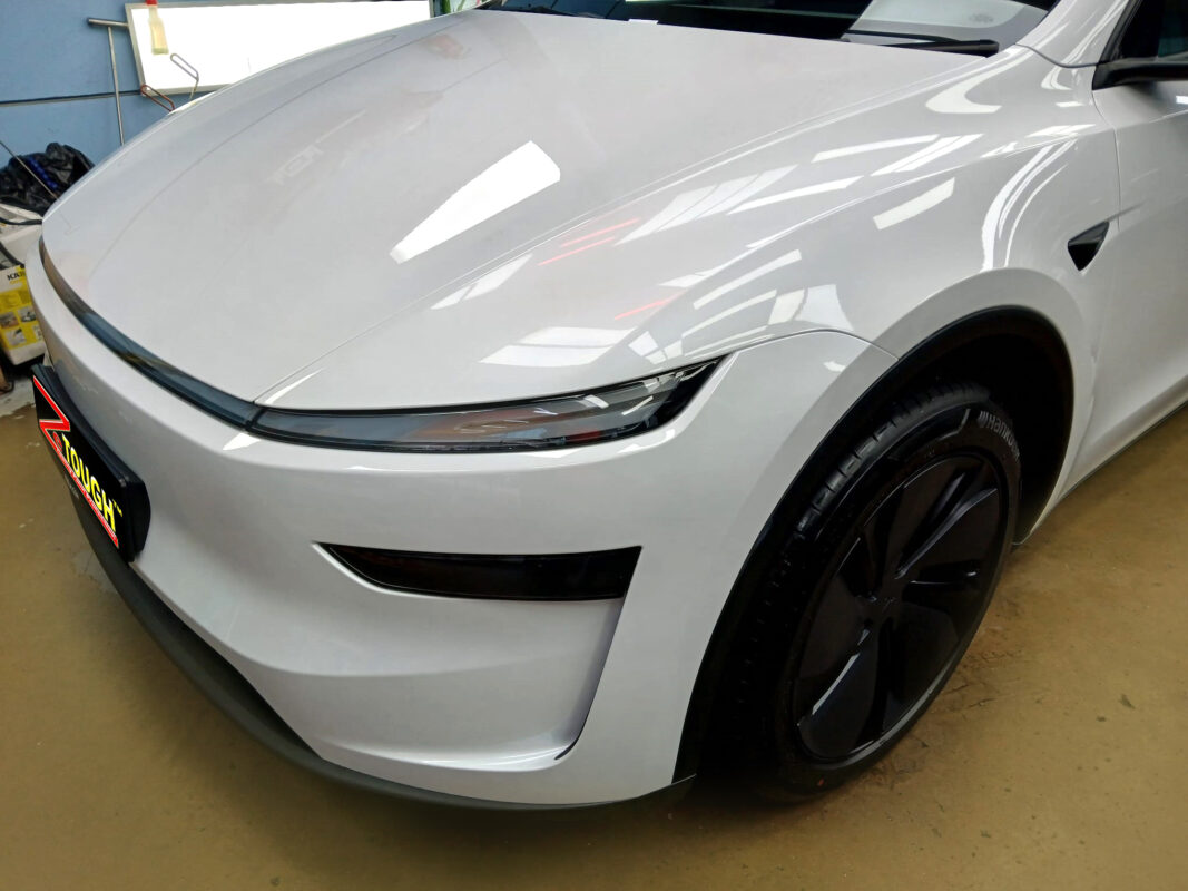 The Tesla Model Y from a side angle after the ceramic coating.