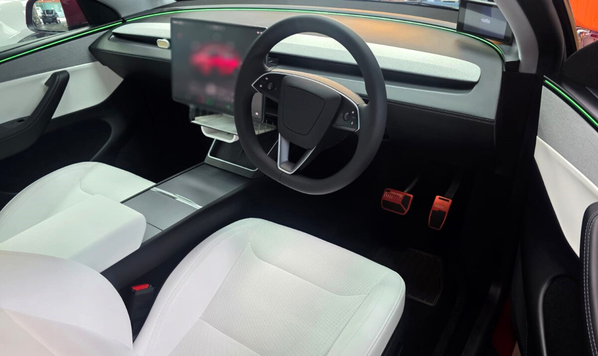 The Tesla Model Y parked in the workshop, freshly coated.