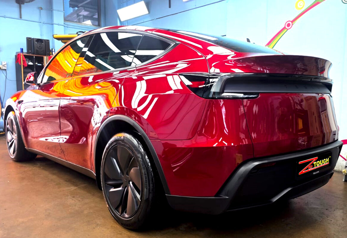 Rear quarter of the Tesla Model Y, glossy and protected.