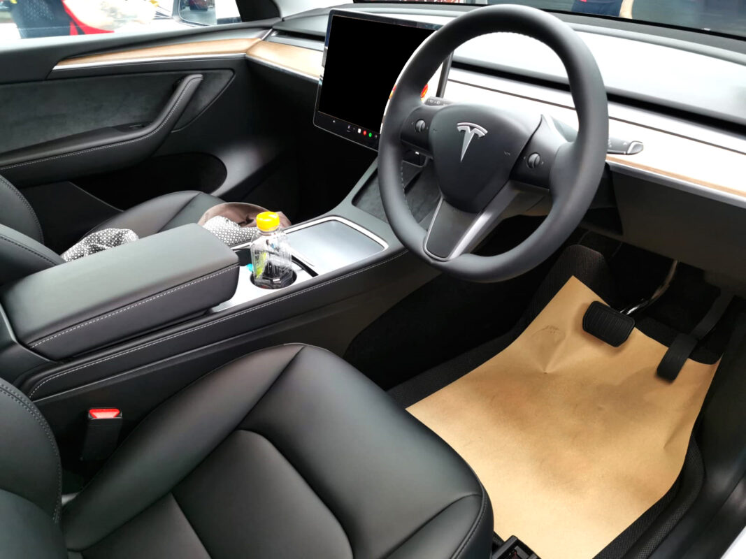 The Tesla Model Y parked in the workshop, freshly coated.
