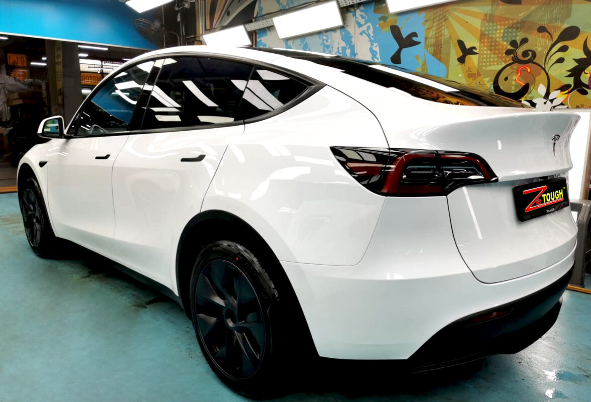 Rear quarter of the Tesla Model Y, glossy and protected.