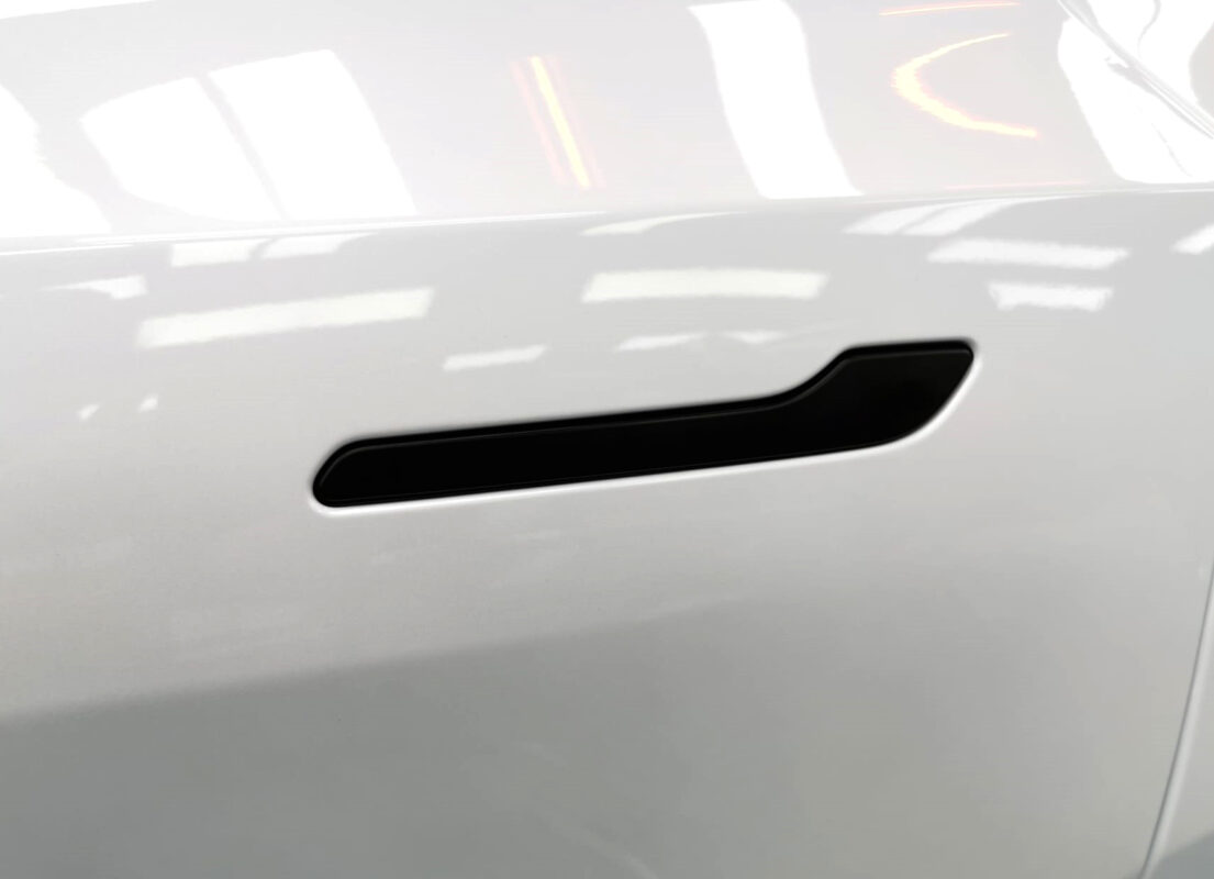 The coated paintwork of the Tesla Model Y, clean and sharp.
