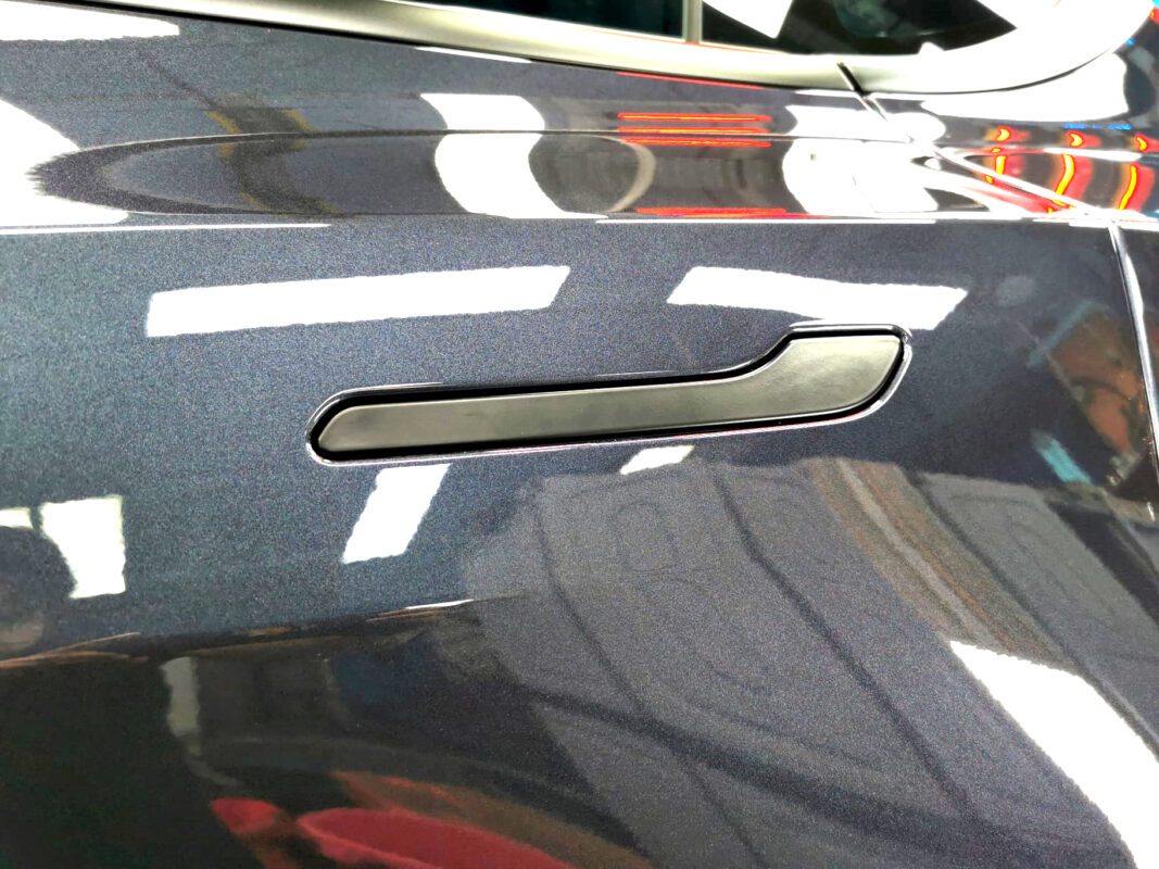 The coated paintwork of the Tesla Model Y, clean and sharp.