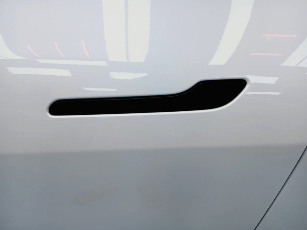 The coated paintwork of the Tesla Model Y, clean and sharp.