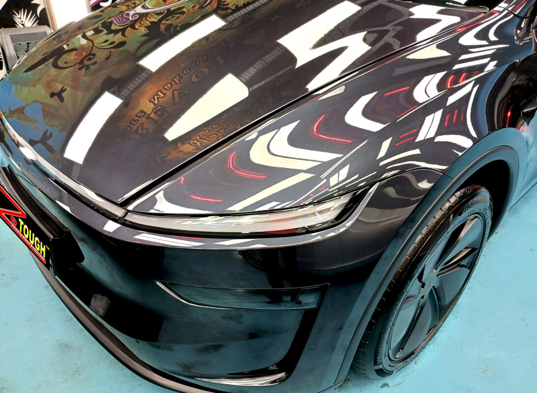 The Tesla Model Y from a side angle after the titanium coating.
