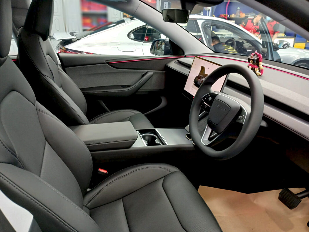 The Tesla Model Y parked in the workshop, freshly coated.