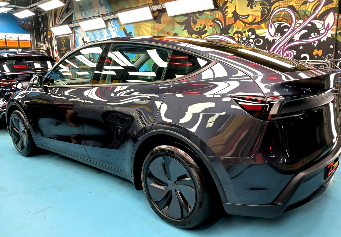 Rear quarter of the Tesla Model Y, glossy and protected.