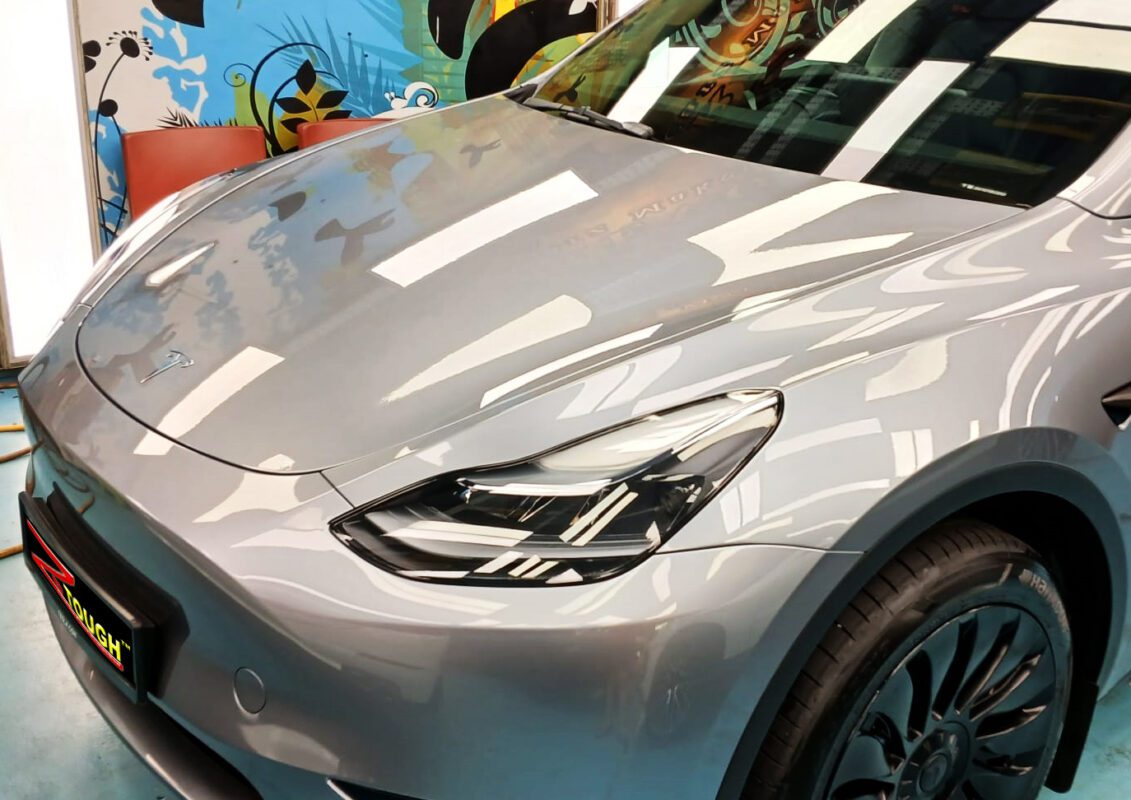 The Tesla Model Y from a side angle after the titanium coating.