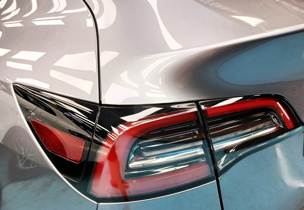 Rear quarter of the Tesla Model Y, glossy and protected.