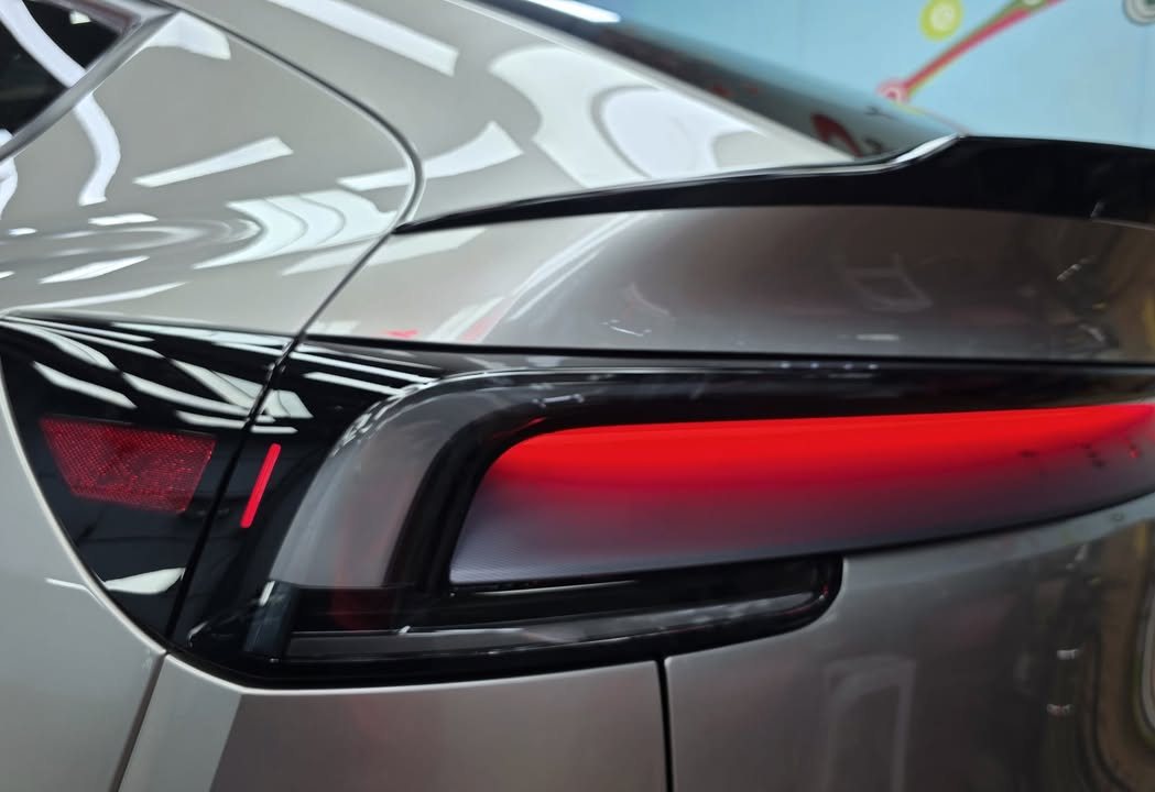 Close-up of the red tail light bar and rear quarter panel.