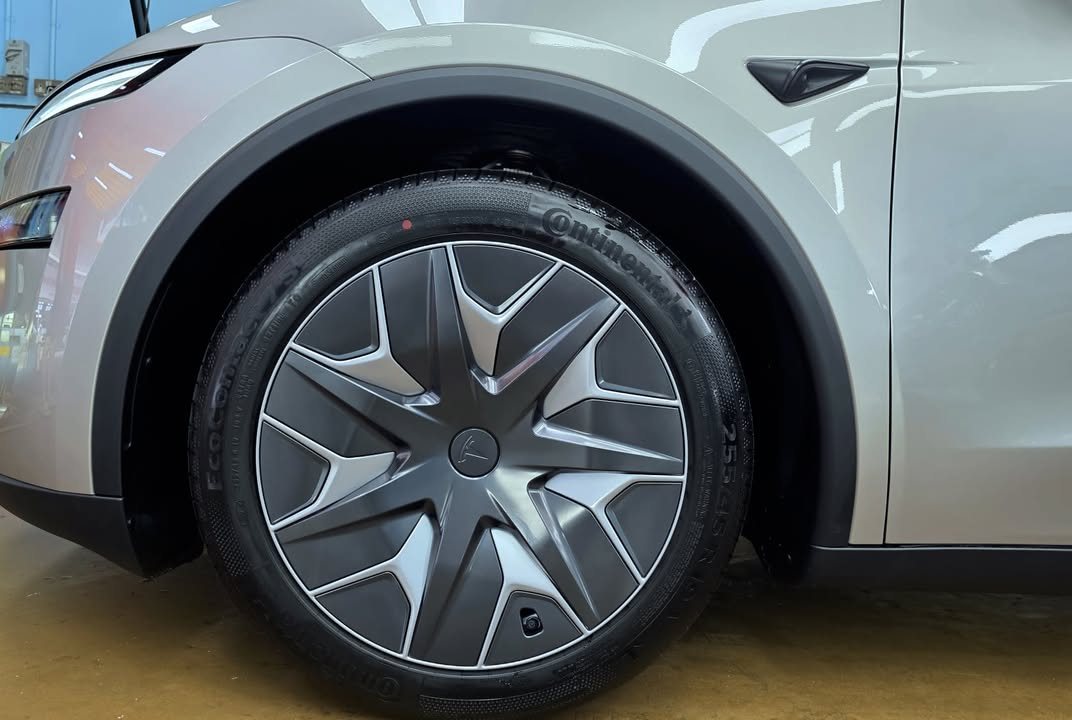Grey aero wheel and tyre under the silver wheel arch.