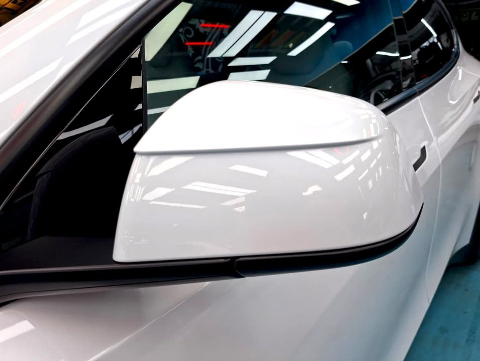 White door mirror on the Tesla Model Y L with a clean gloss.