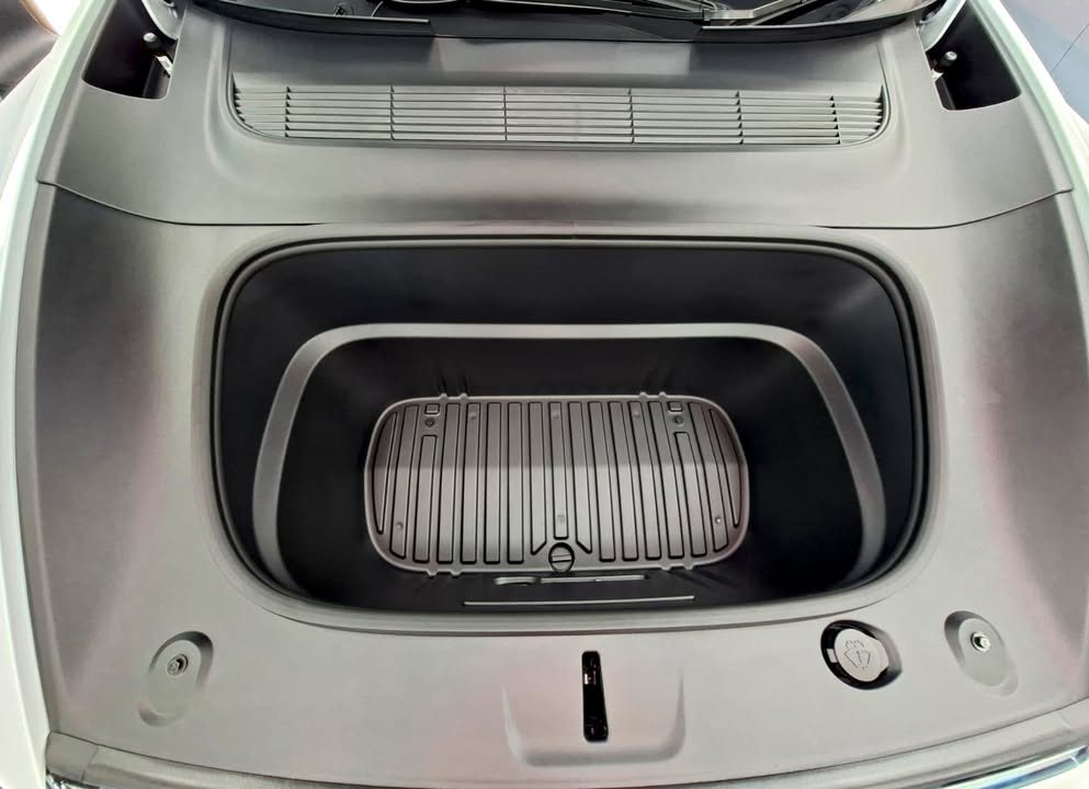 Front trunk of the Tesla Model Y L with a grey ribbed liner.