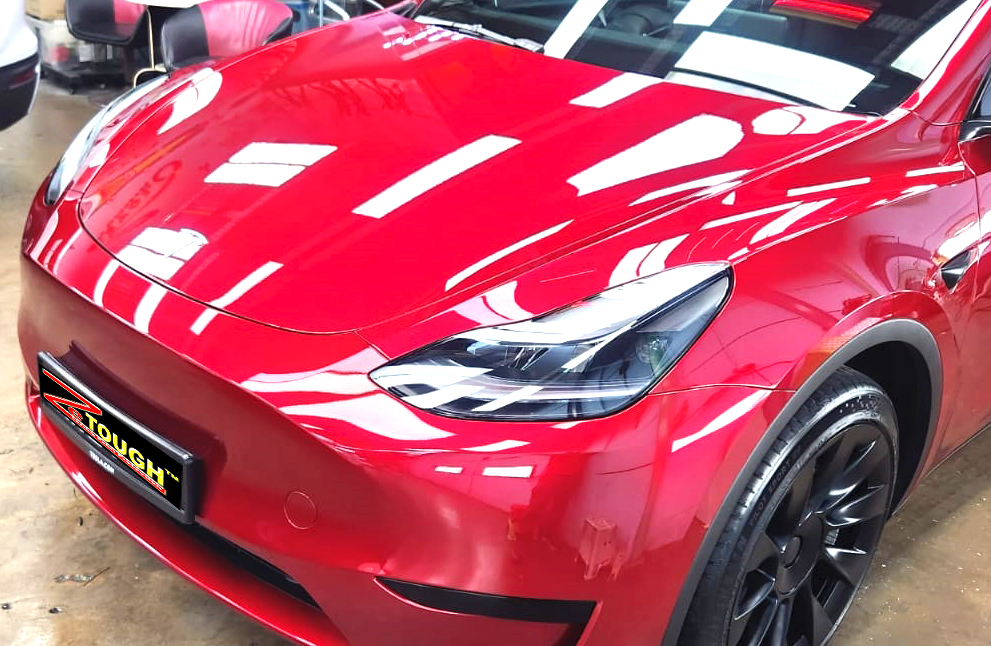 The Tesla Model Y from a side angle after the ceramic coating.