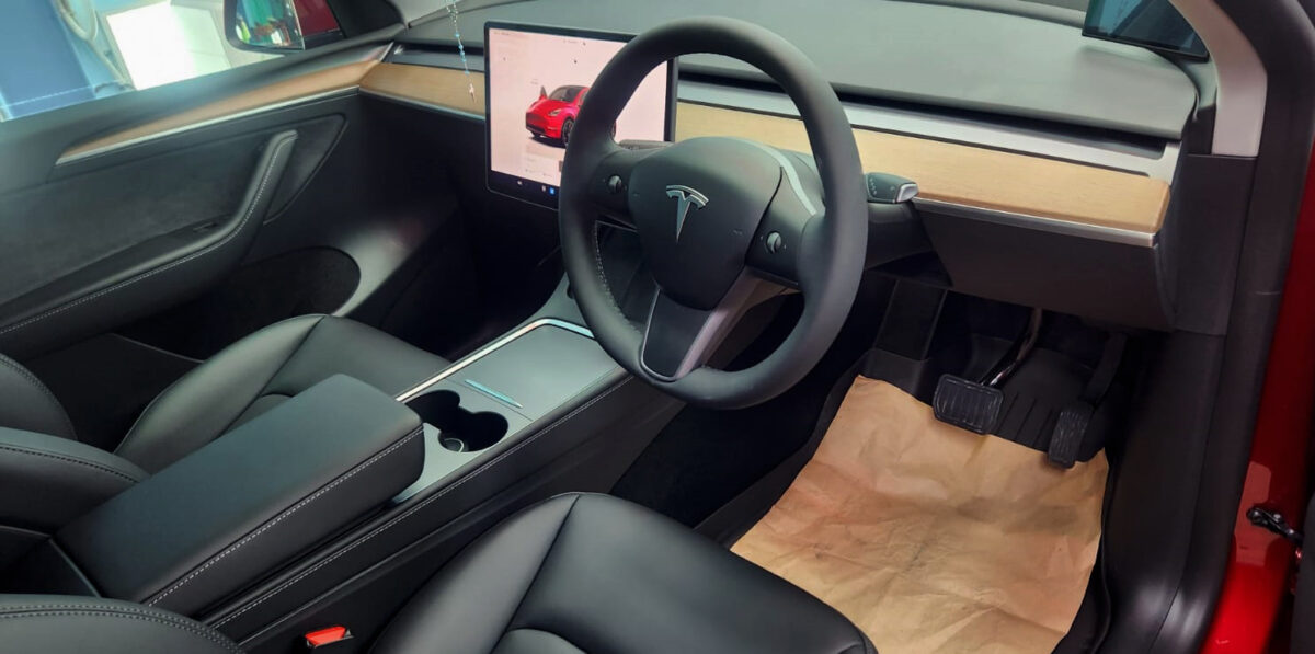 The Tesla Model Y parked in the workshop, freshly coated.