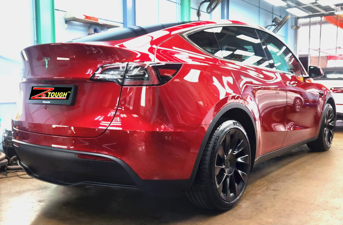 Rear quarter of the Tesla Model Y, glossy and protected.