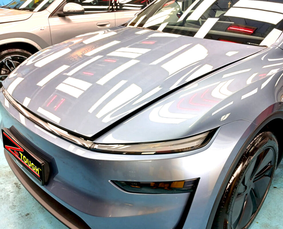 The Tesla Model Y from a side angle after the titanium coating.