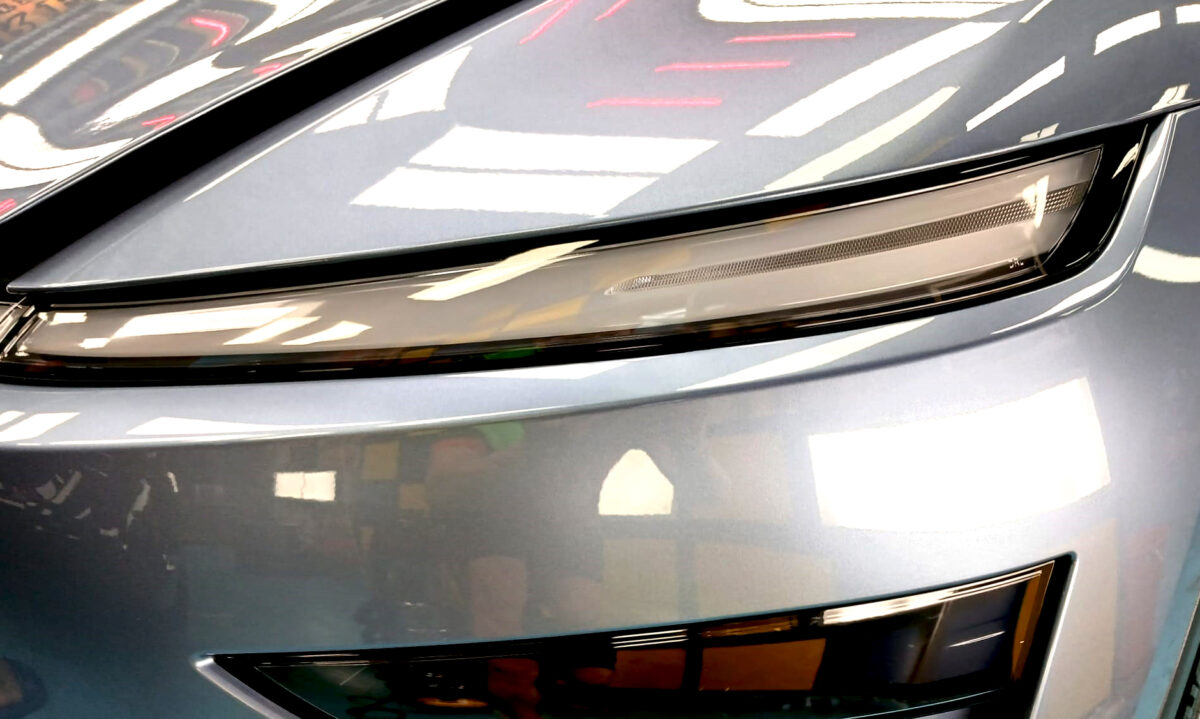 The Model Y's coated paintwork showing clean reflections.