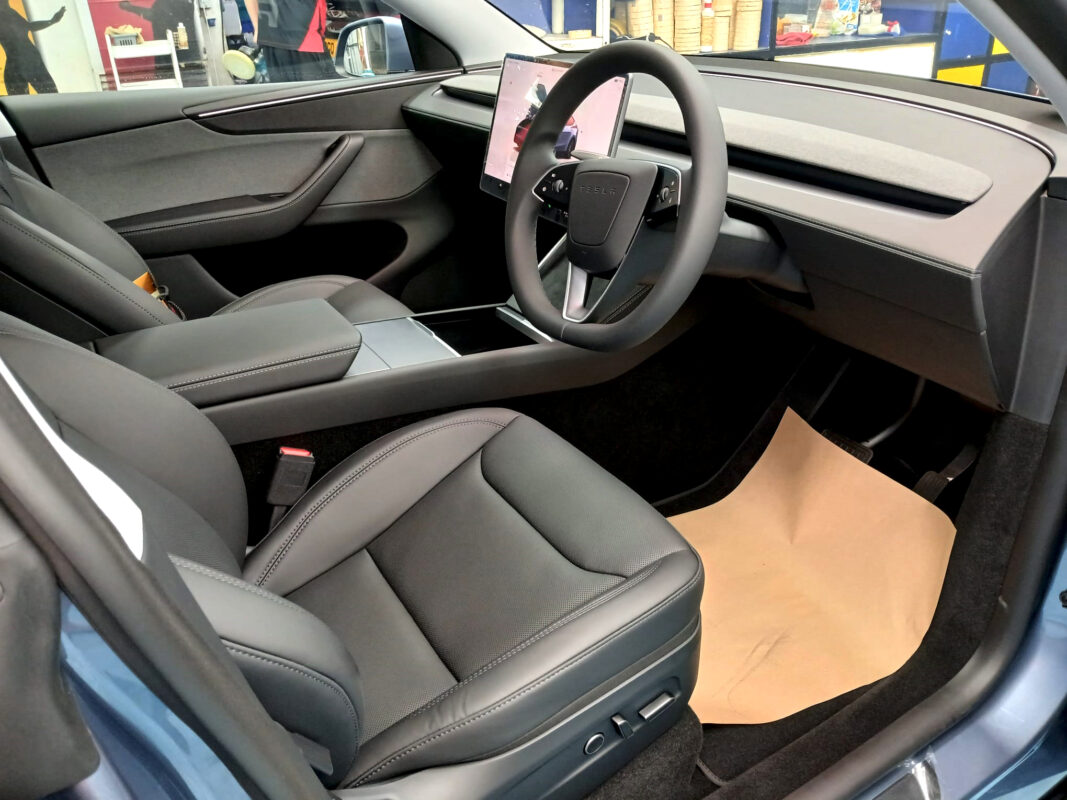 The Tesla Model Y parked in the workshop, freshly coated.