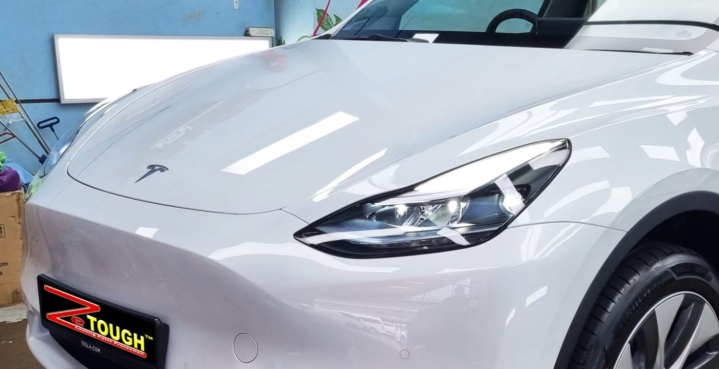The Tesla Model Y from a side angle after the ceramic coating.