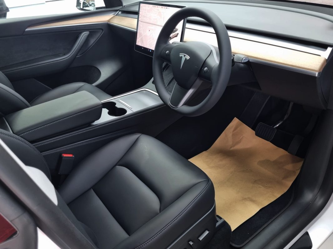 The Tesla Model Y parked in the workshop, freshly coated.
