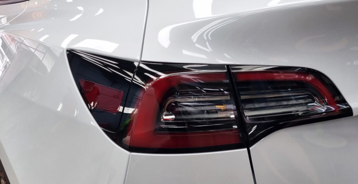 Rear quarter of the Tesla Model Y, glossy and protected.