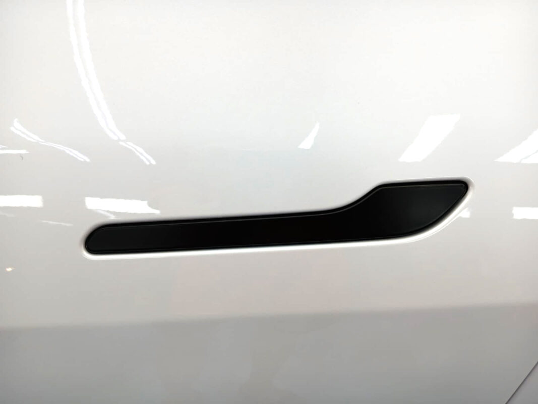 The coated paintwork of the Tesla Model Y, clean and sharp.