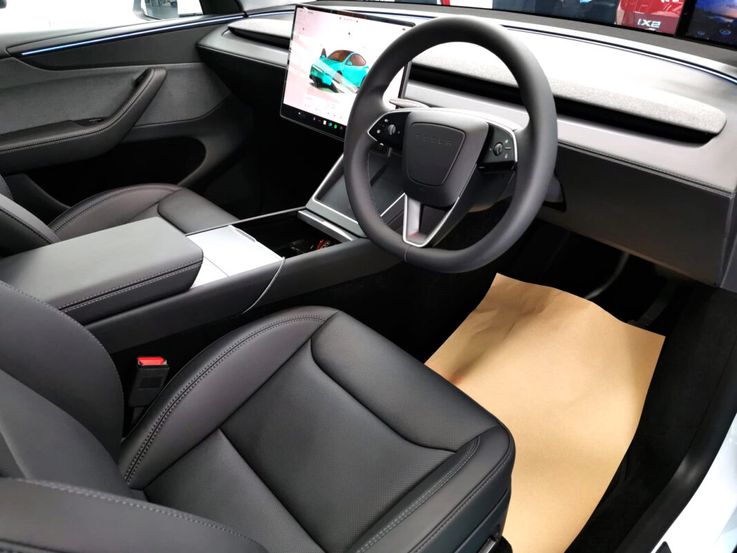 The Tesla Model Y parked in the workshop, freshly coated.