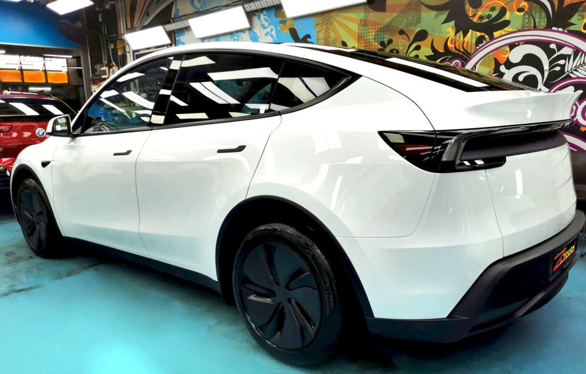 Rear quarter of the Tesla Model Y, glossy and protected.