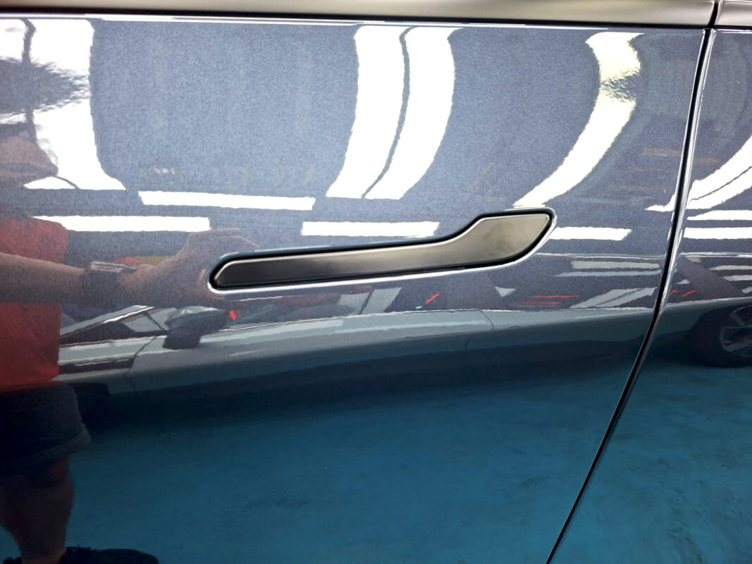 The coated paintwork of the Tesla Model Y, clean and sharp.