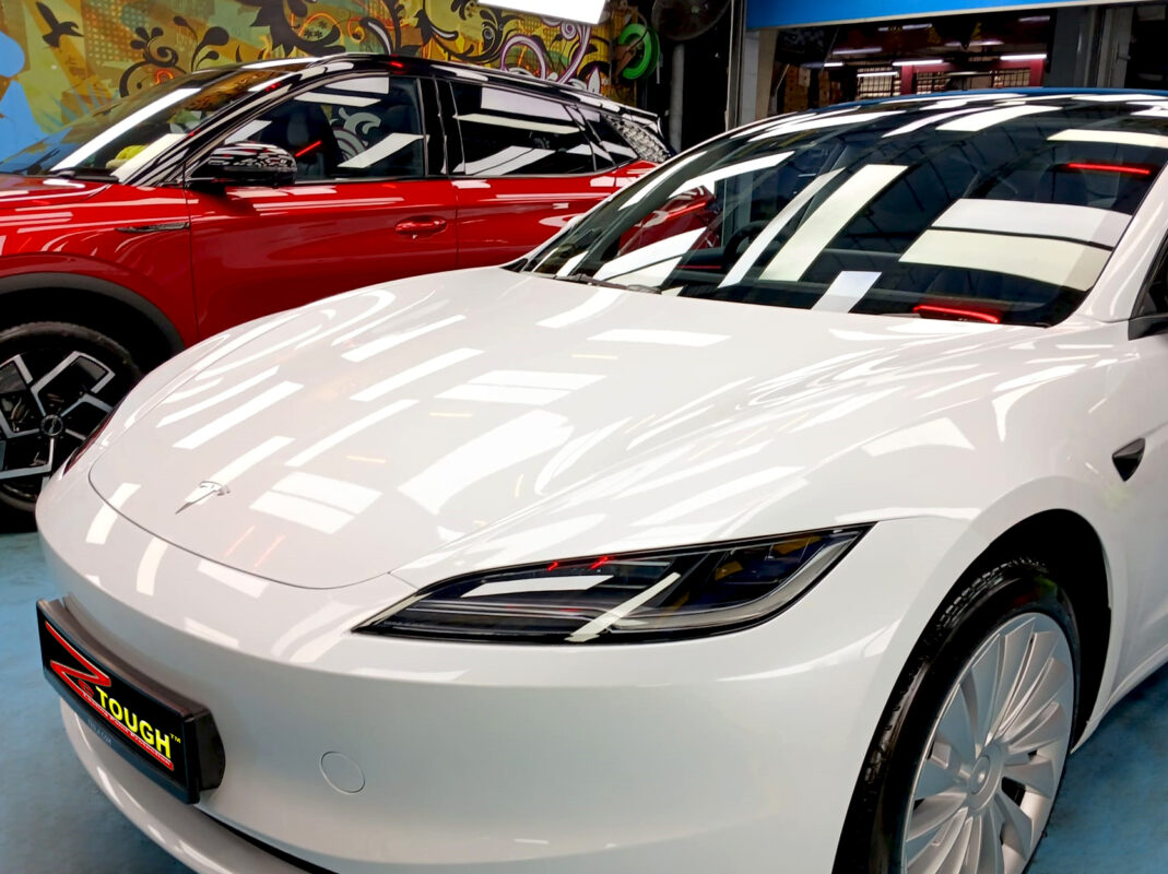 The Tesla Model 3 from a side angle after the titanium coating.