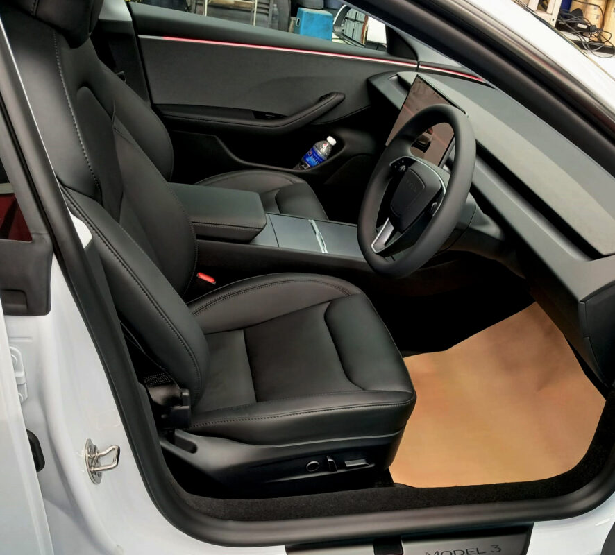 The Tesla Model 3 parked in the workshop, freshly coated.