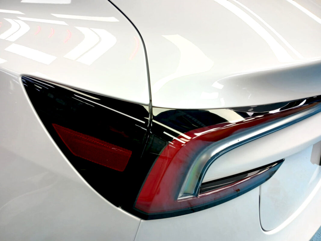 Rear quarter of the Tesla Model 3, glossy and protected.