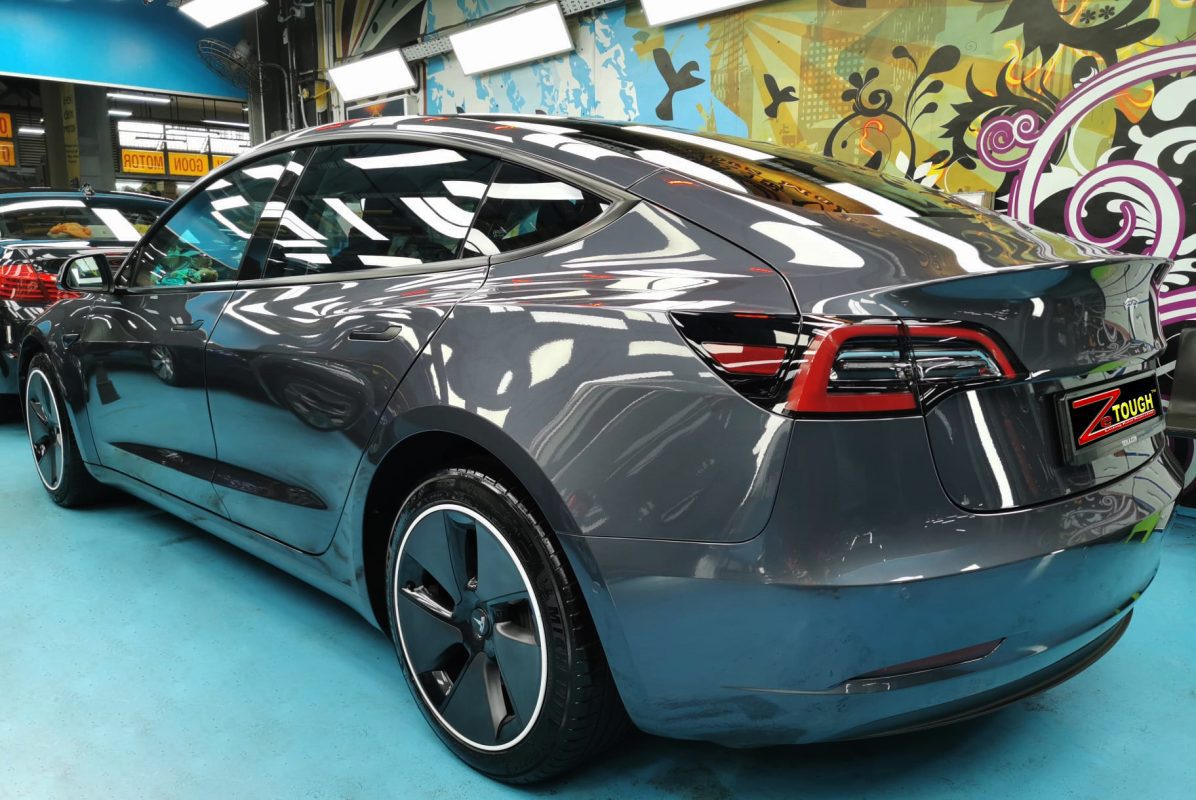 Rear quarter of the Tesla Model 3, glossy and protected.